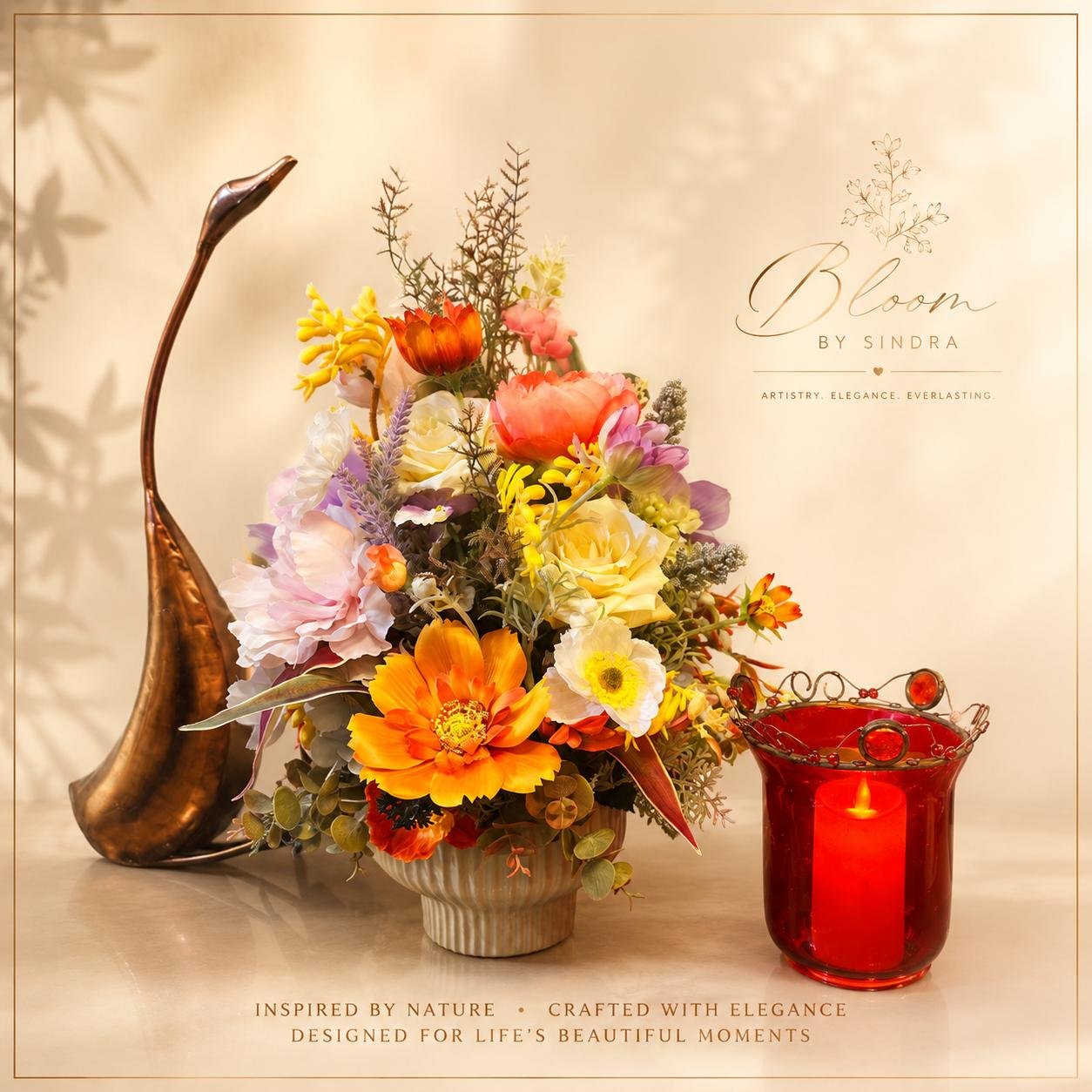 Bloom by Sindra branded photo of a multicoloured rose and peony bouquet beside a bronze crane and red candle holder